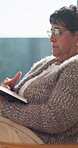 Bible, reading and religion with old woman in living room for Christian belief or spiritual study. Book, faith and learning with senior person on chair in retirement home for gospel, hope or trust