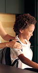 Smile, mother and help child with backpack in kitchen for education support, back to school and morning routine. African family, woman and greeting boy in home for bonding and getting ready to leave
