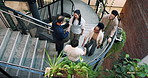 Business people, meeting and handshake on office stairs for welcome, introduction or smile. Above, realtor team or colleagues shaking hands for greeting or hiring, recruiting and onboarding in agency