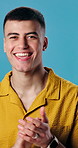 Success, face and man in studio with clapping, goal achievement or encouragement with positive gesture. Happy, portrait or person with applause, motivation or winning expression on blue background.