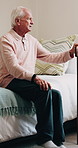 Senior, man and thinking with cane in bedroom for retirement, past moment or nostalgia in home. Thoughtful, elderly or male person contemplating on bed with vision or reflection for memory in house