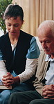 Woman, nurse or praying with senior man in retirement home for faith, religion or belief together. Female person, healthcare worker or caregiver with holy book, bible or elderly care for christianity
