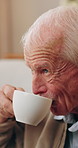 Senior, thinking and man with coffee in house for morning beverage, nostalgia or past moment. Thoughtful, elderly or male person with cup or mug for caffeine, memory or remember in old age home