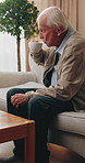 Senior, man and drinking with coffee in retirement home for morning beverage or waiting on sofa. Elderly, male person or thinking with cup, mug or past memory for caffeine, nostalgia or remember