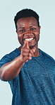 Face, fitness or black man with motivation in studio for sign up or registration on a blue background. Portrait, active or male person pointing to you with smile or muscle flex for health or wellness