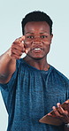 Face, fitness or black man with clipboard in studio for sign up or membership on a blue background. Portrait, male person or coach pointing to you with bicep flex for registration, health or wellness