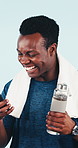 Happy, fitness or black man winning with phone in studio for good news on a blue background. Excited, active or male person with smile, water or smartphone in celebration for workout goals or success