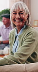 Face, smile and senior woman in home to relax, wellness or positive attitude with comfort on sofa. Portrait, retirement and person at living room on break with peace, happy or calm with friends