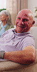 Face, laugh and senior man in home to relax, wellness and positive attitude with friends on sofa. Portrait, retirement and funny person at living room on break with peace, happy or calm with comfort
