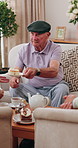 Senior, man and cupcake in retirement home with friends, conversation and relax for bonding together. Elderly people, talk and sweet treats in living room for dessert, gossip and social gathering.