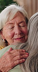 Support, hug and old woman in home with friends for connection, trust and happiness together. Retirement, people and embrace with smile for bonding, talking or comfort with wellness at apartment