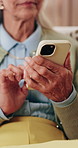 Phone, hands and senior woman on sofa in home for texting, research or chatting on mobile app. Relax, cellphone and elderly person in retirement with reading blog, website or social media in house.