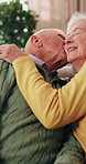 Love, kiss and old couple in home with hug, connection and smile for bonding together in retirement. Happy, married senior people and relax in living room with embrace, care or romantic relationship.
