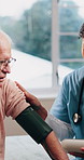 Nurse, elderly and patient with blood pressure machine in bedroom for healthcare checkup or exam. Woman, health worker or monitoring man with arm strap for medical test or senior care in nursing home