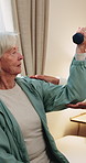 Physio, exercise and senior woman with dumbbell for health, shoulder rehabilitation or care. Retirement, elderly person or physiotherapist in office with joint mobility or weights for muscle growth
