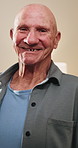 Smile, face and senior man in home for wellness, relax and happy for comfort in retirement. Laugh, portrait and elderly person in house with positive outlook, peace and good memories or nostalgia