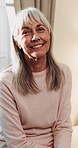 Smile, face and elderly woman in home for wellness, relax and happy for comfort in retirement. Laugh, portrait and senior person in house with positive outlook, peace and good memories or nostalgia