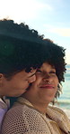 Kiss, hug and couple by beach on holiday, getaway or weekend trip for bonding in marriage together. Happy, outdoor and man embracing woman with love, trust and care by ocean on summer vacation.
