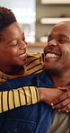 Father, laughing and relax with son hug in home living room for bonding, love or security. Black family, connection and funny with excited boy embracing man in apartment for development or support