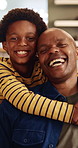 Face, father and laughing with son hug in home living room for bonding, love or security. Black family, connection and funny with boy embracing excited man in apartment for development or support