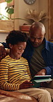 Dad, child and tablet on sofa for elearning, bonding and educational app in home. Black family, man and son with tech for streaming subscription, growth and online development for boy in lounge