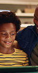 Father, child and tablet on sofa for elearning, bonding and educational app in home. Black family, man and son with tech for streaming subscription, growth and online development for boy in lounge