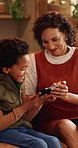 Family, phone and gaming on sofa with mother, son and bonding or happy in home living room. Mobile game, love and smile on couch with African woman, mom and child for online app or challenge together