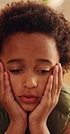 Sad, reflection and kid with depression in home, loneliness and bad memory with trauma. Thinking, unhappy child and African boy with anxiety, boredom or stress with mental health crisis in lounge