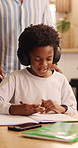 Child, headphones and writing with dad for elearning, virtual lesson or online help in home. African family, student and digital tech for distance learning, education app or father for homeschooling