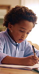 Education, thinking and writing with child in home for homework, learning and knowledge. Assignment, notebook and problem solving with African boy in apartment for student development or study