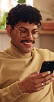 Phone, relax and man on sofa in home with texting, chatting or communication on social media app. Happy, technology and person with cellphone for typing email inquiry on website in apartment.