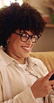 Woman, smile and typing in home with phone, glasses and social media app for reading online gossip. Person, relax and browsing in lounge with tech, internet connectivity and happy for text message.