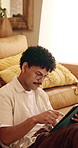Man, scroll and remote work in house with tablet, glasses and creativity for editing logo design. Freelancer, person and graphic designer in home with tech, planning and research trends for campaign.