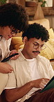 Couple, talk and relax in home with tablet, internet connection or opinion for online shopping together. Happy people, dating and chat in living room with tech, website and digital app for ecommerce.