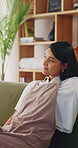 Relax, thinking and woman on sofa in home for decision, ideas or planning for weekend break. Smile, choice and person in living room with reflection, nostalgia or remember memory in apartment.