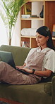 Woman, typing and remote work on couch with laptop, research and laugh for funny online blog post. Happy, freelance writer and person in home with computer, browsing website and humor for article.