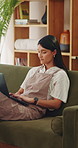 Woman, typing and remote work in apartment with laptop, research and writing column for blog post. Freelance writer, person and creative in home with computer, planning and draft article for website.