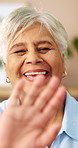Face, old woman and happy with wave on video call for social connection, contact or heart hands. Laugh, senior person and hello on virtual chat in home for conversation, catch up or love emoji on POV