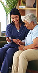 Caregiver, help and old woman in retirement home with phone, advice and smile for website navigation. Happy, nurse and senior person on sofa with tech setup, app and assistance for digital literacy.