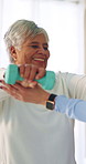 Senior, therapist and happy woman with dumbbells for weightlifting exercise or strength recovery. Female person, physiotherapist and elderly patient with smile or arm workout for health or wellness