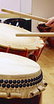 Taiko, practice or hands in studio with drums, traditional activity or audio skill in performance. Percussion, rehearsal or person with instrument, sound control or music training in Japanese culture