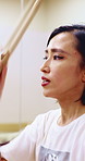 Taiko, rehearsal or Asian woman in studio with drums, tradition or audio skill in performance. Percussion, practice or musician with instrument, sound control or music training in Japanese culture.