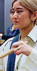 Taiko, training or Asian woman in class with drum, cultural activity or audio coordination in band practice. Percussion, tradition or people with instrument, group rehearsal or music lesson in Japan.