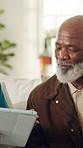 Doctor, talk and old man in house with tablet, explain test results and medical advice for wellness. Senior person, healthcare worker and home visit with tech, black people or research for diagnosis.