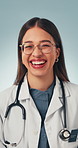 Face, healthcare and laughing with woman in studio for satisfaction, trust or wellness. Glasses, funny and medicine with excited doctor on gray background for pride in professional medical career