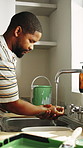 Renovation, paint or black man in home with washing hands, toxic exposure or safety in contamination hazard. Hygiene, scrub or painter with water, chemical precaution or risk prevention in remodeling