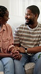 Happy, couple and holding hands in new home with conversation, love or bonding together for relocation. Married, black people and moving in dream house with smile, discussion or relationship support.