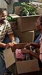 Couple, laugh and unpacking in new home with clothes, funny conversation and bonding for relocation. High angle, married black people and moving in house with boxes, apparel and happy relationship.