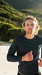 Fitness, man and running at beach for wellness, cardio and sports with endurance practice in nature. Jog, runner and person outdoor for workout, health benefits and training with energy for exercise