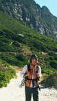 Walking, hiking and man in nature for journey, adventure or reflection on trip for exploration on vacation. Trekking, holiday and person outdoor for tourism, travel and thinking by mountain
